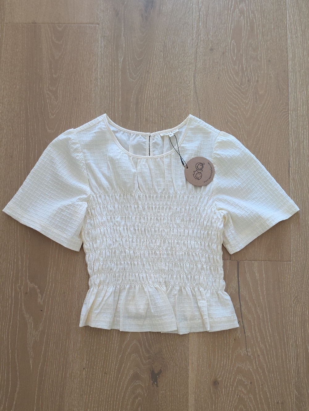Smocked Short Sleeve Peplum Blouse in White